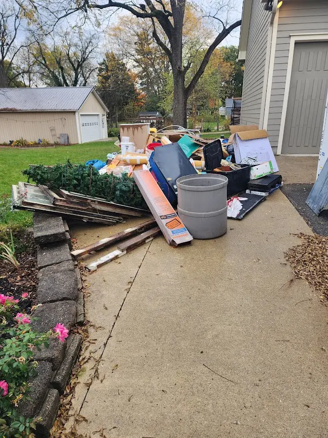 Dumpster being loaded with debris for Estate Cleanout Dumpster Rental in Nutley